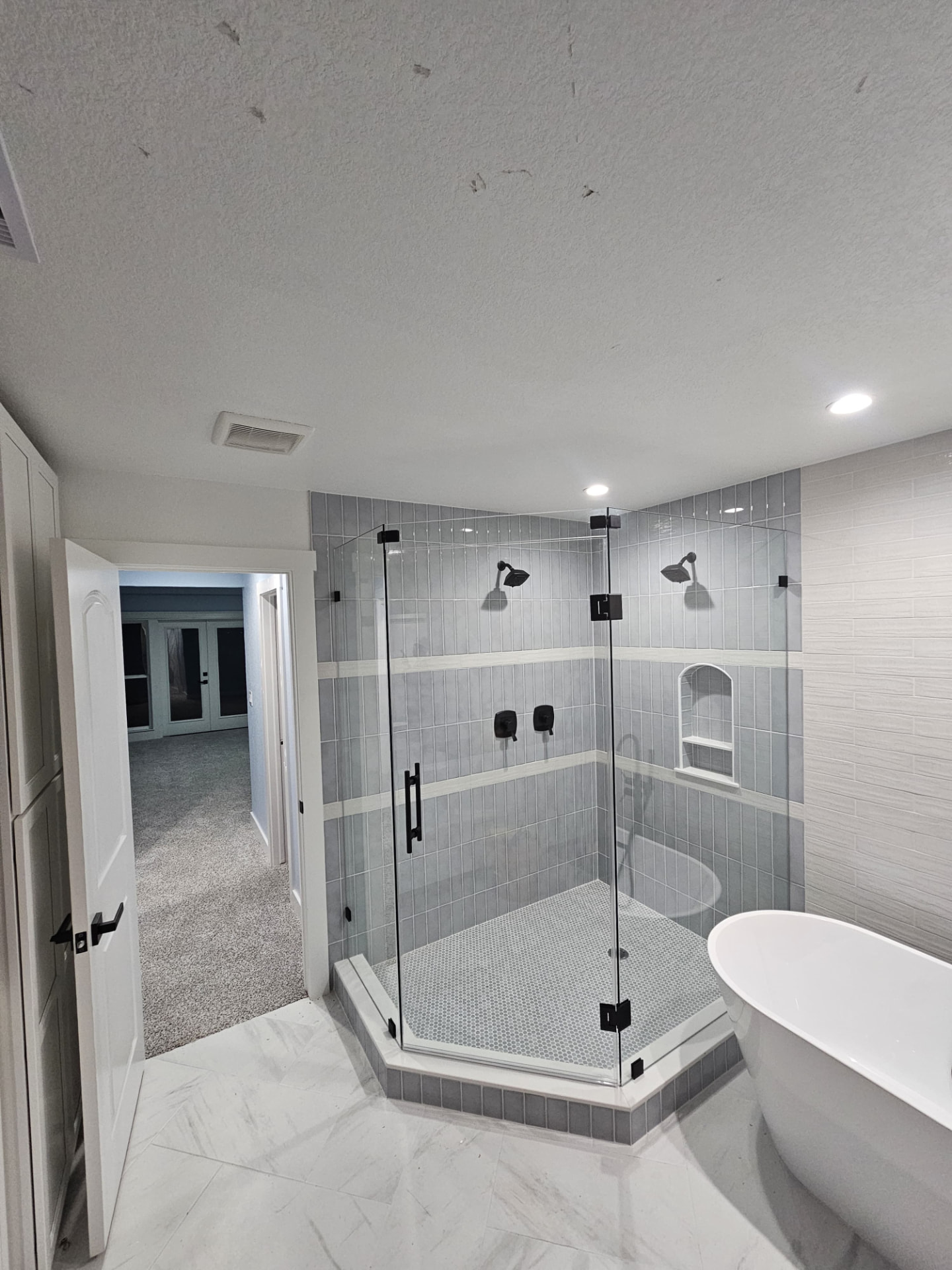 Corner shower enclosure by Racso Glass LLC